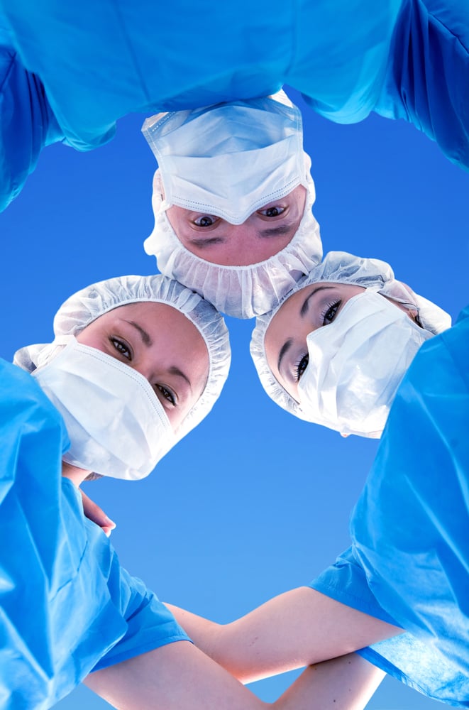 surgical team in uniform isolated over blue